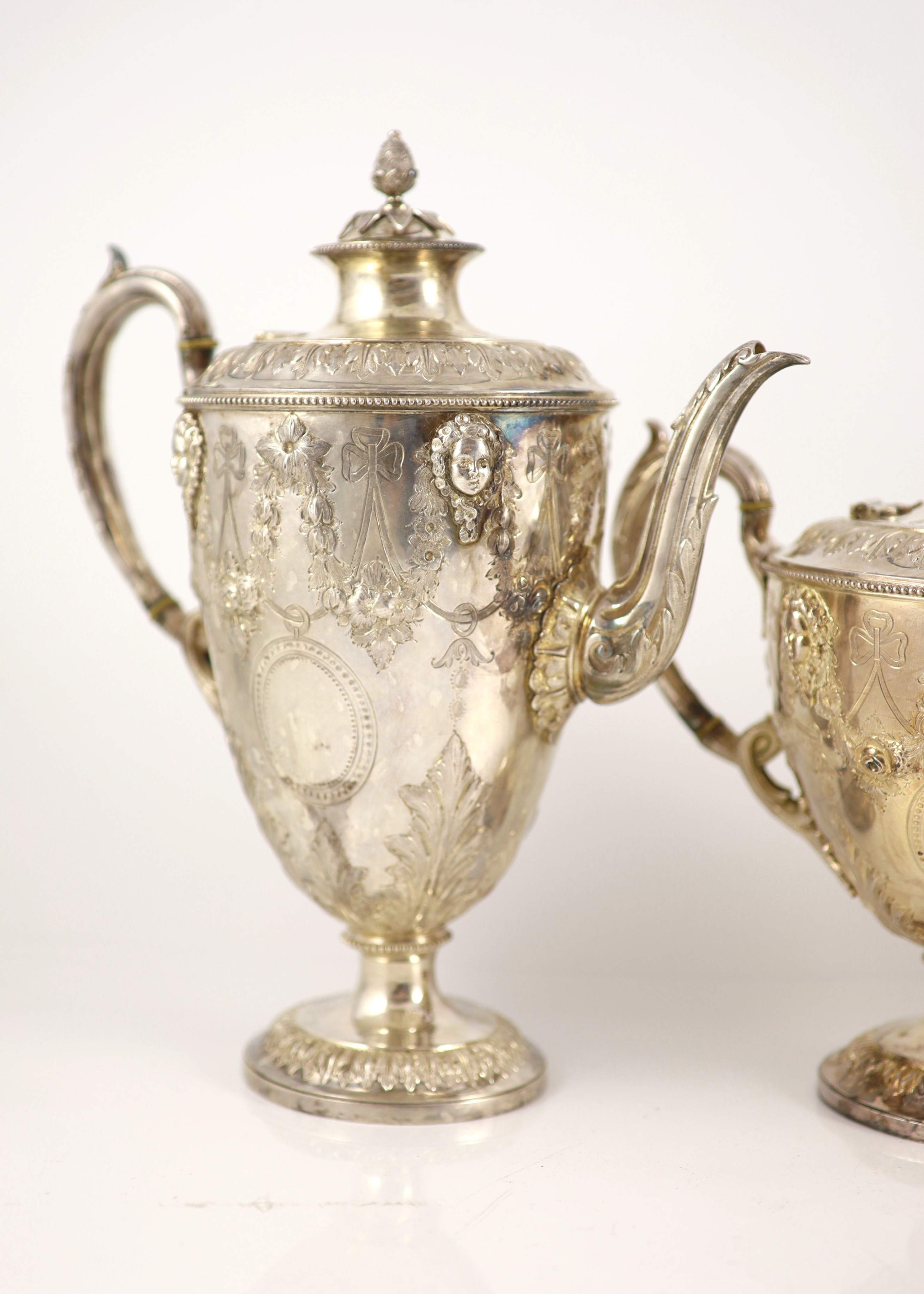 A Victorian embossed silver four-piece tea and coffee service of classical vase form, London 1886, Martin, Hall & Co (Richard Martin & Ebenezer Hall)